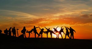 people dancing in the sunset