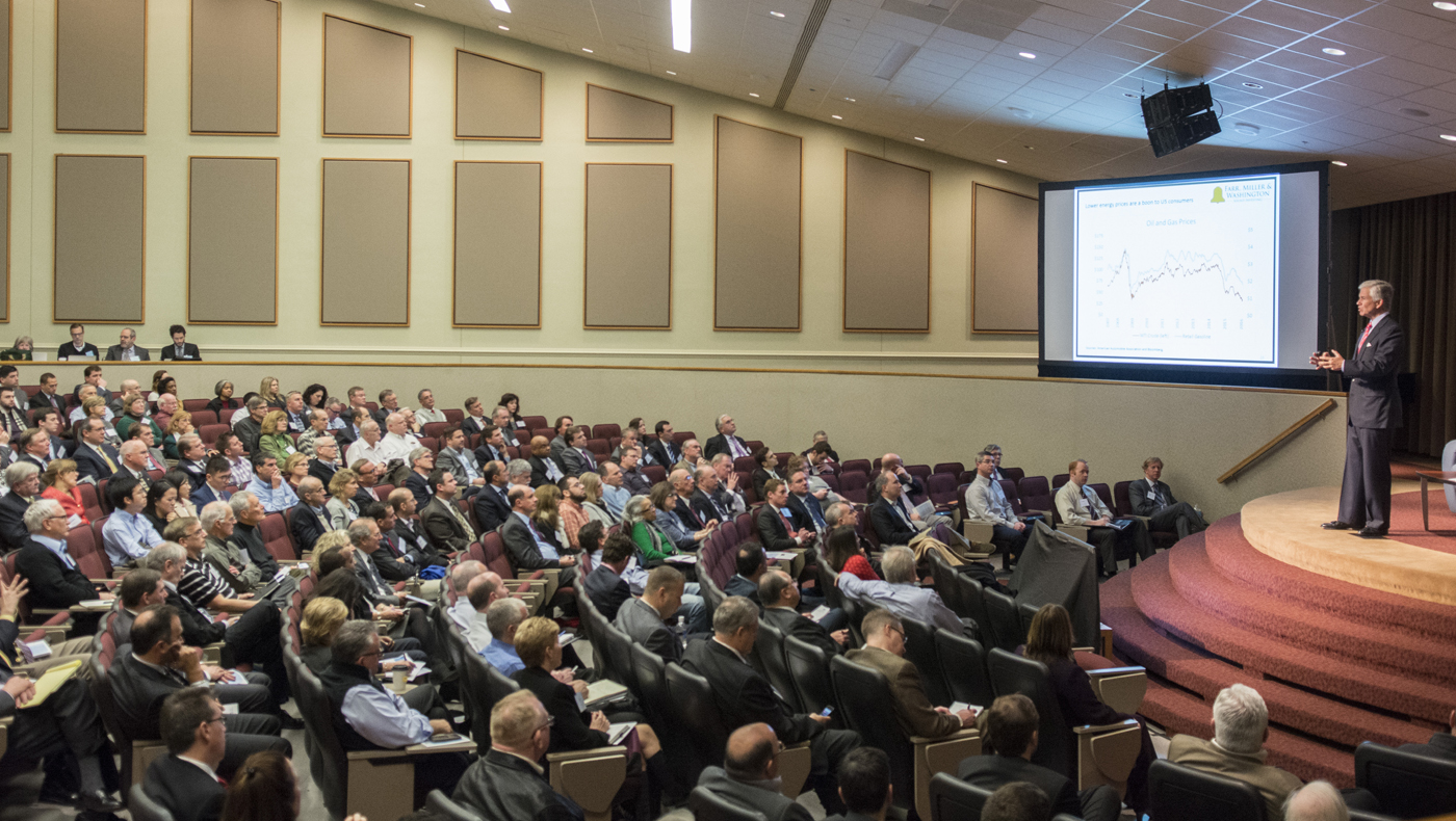 man giving lecture in full lecture hall