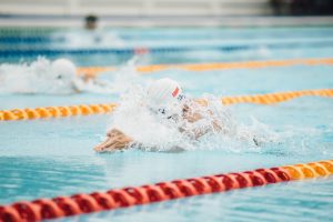 Person swimming in lanes at a pool