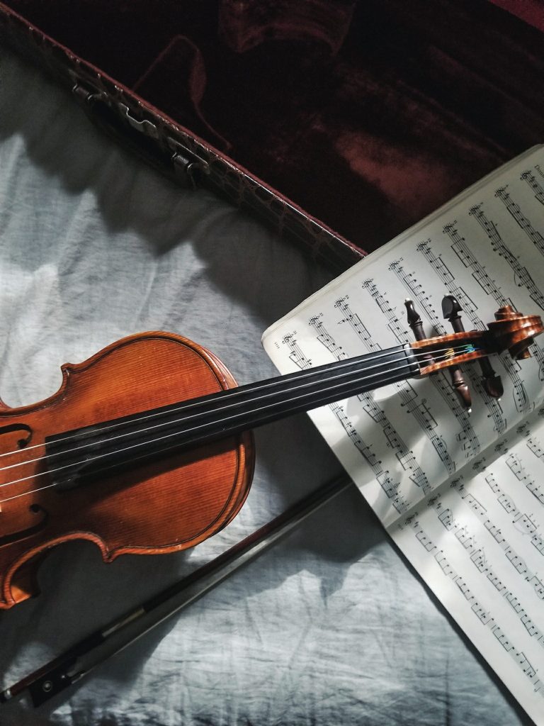 A picture of a violin and a music book