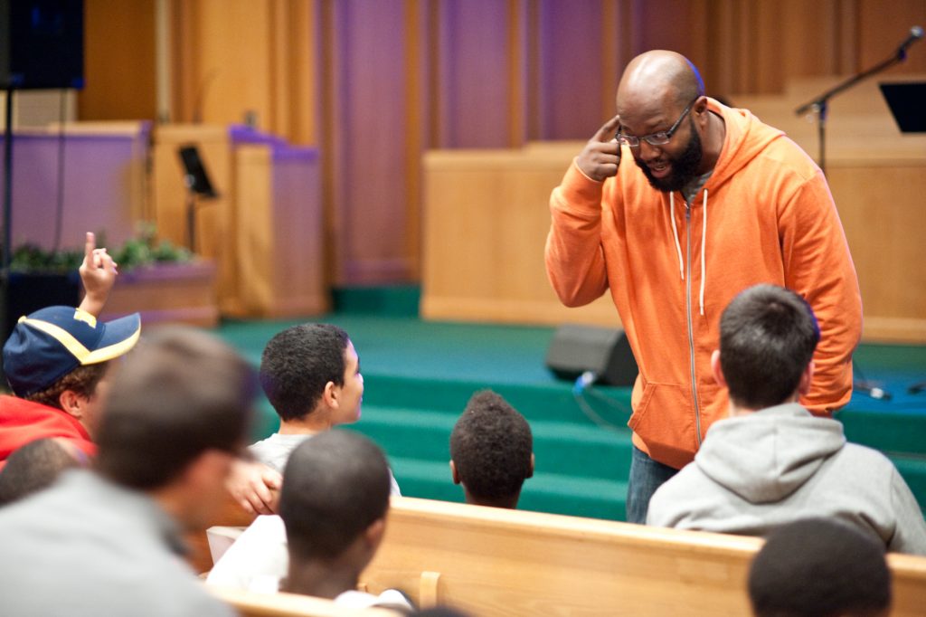 A man teaching the youth.