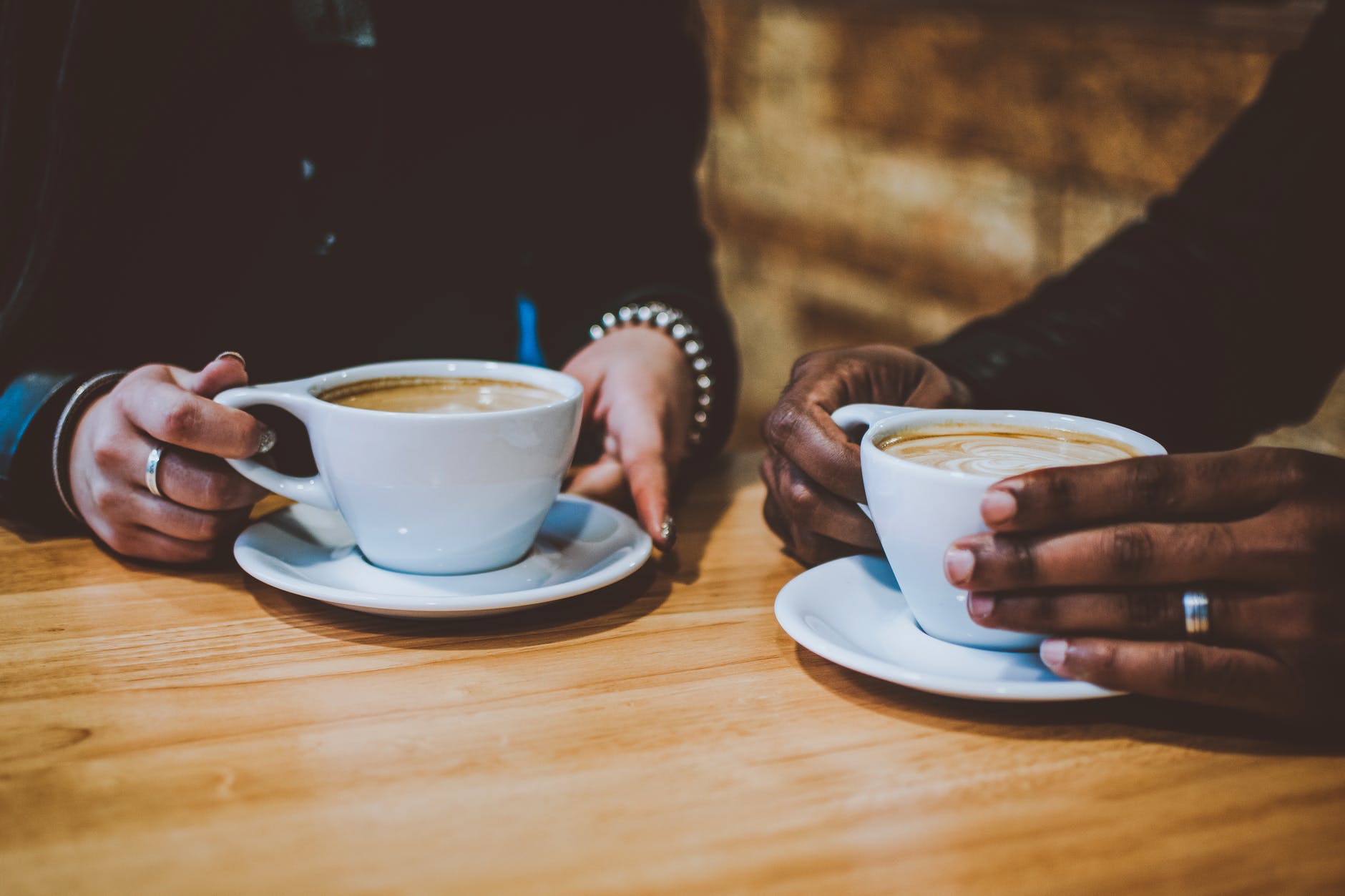 Two people drinking mugs of coffee