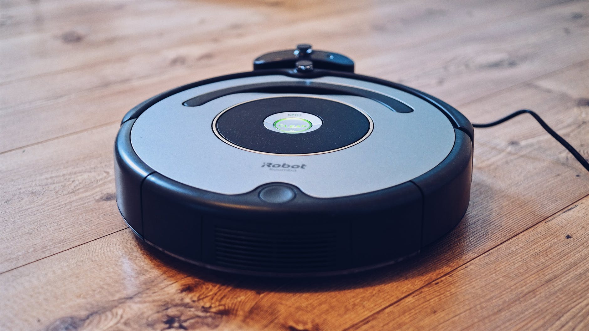 Roomba vacuum on hard wood floor