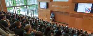 A person lecturing in a lecture hall