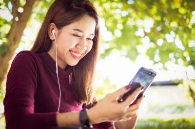 Woman listening to an audio file on her phone