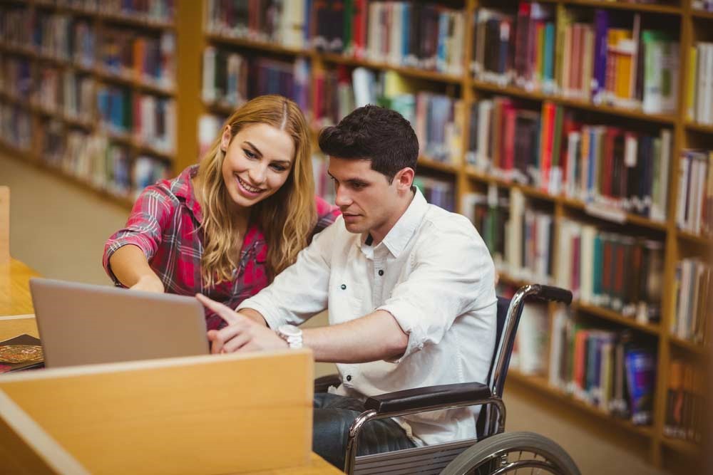 Librarian offering assistance a disabled student – Bethel university library