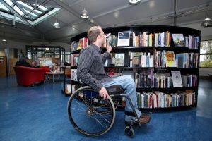 a person in a wheel chair accessing a library