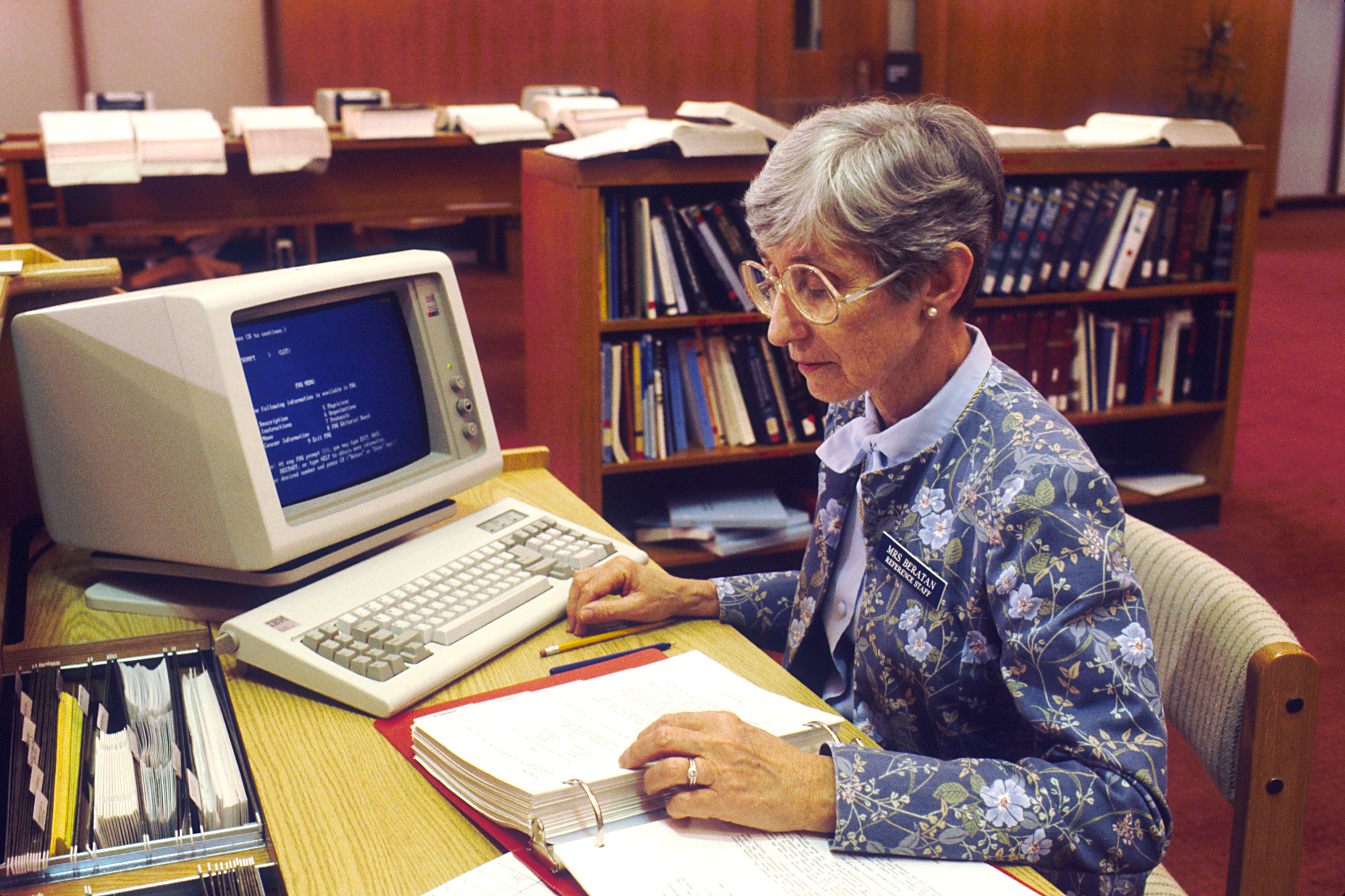 A librarian keeping a record of issued books.