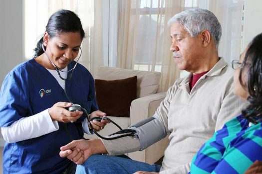Nurse checking blood pressure of patient