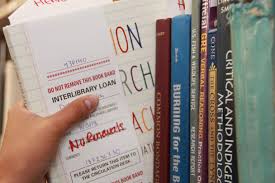 Librarian holding a bunch of books