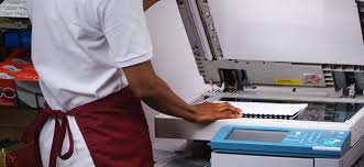 A close-up picture of a student operating a printer