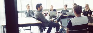 A group of people listening to a speaker