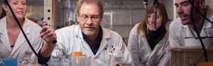 four scientists in the lab with a pipette