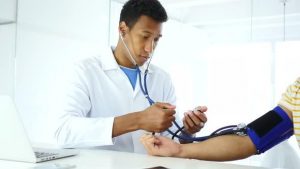 Doctor monitoring the blood pressure of the patient