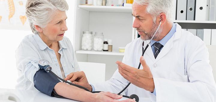 Doctor checking patient’s blood pressure