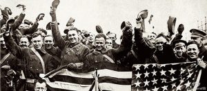 Soldiers raising their hats in elation