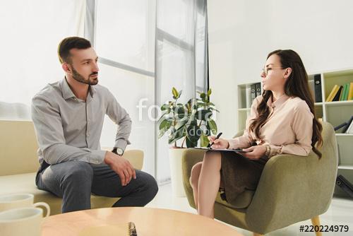 A man and women sitting on chairs