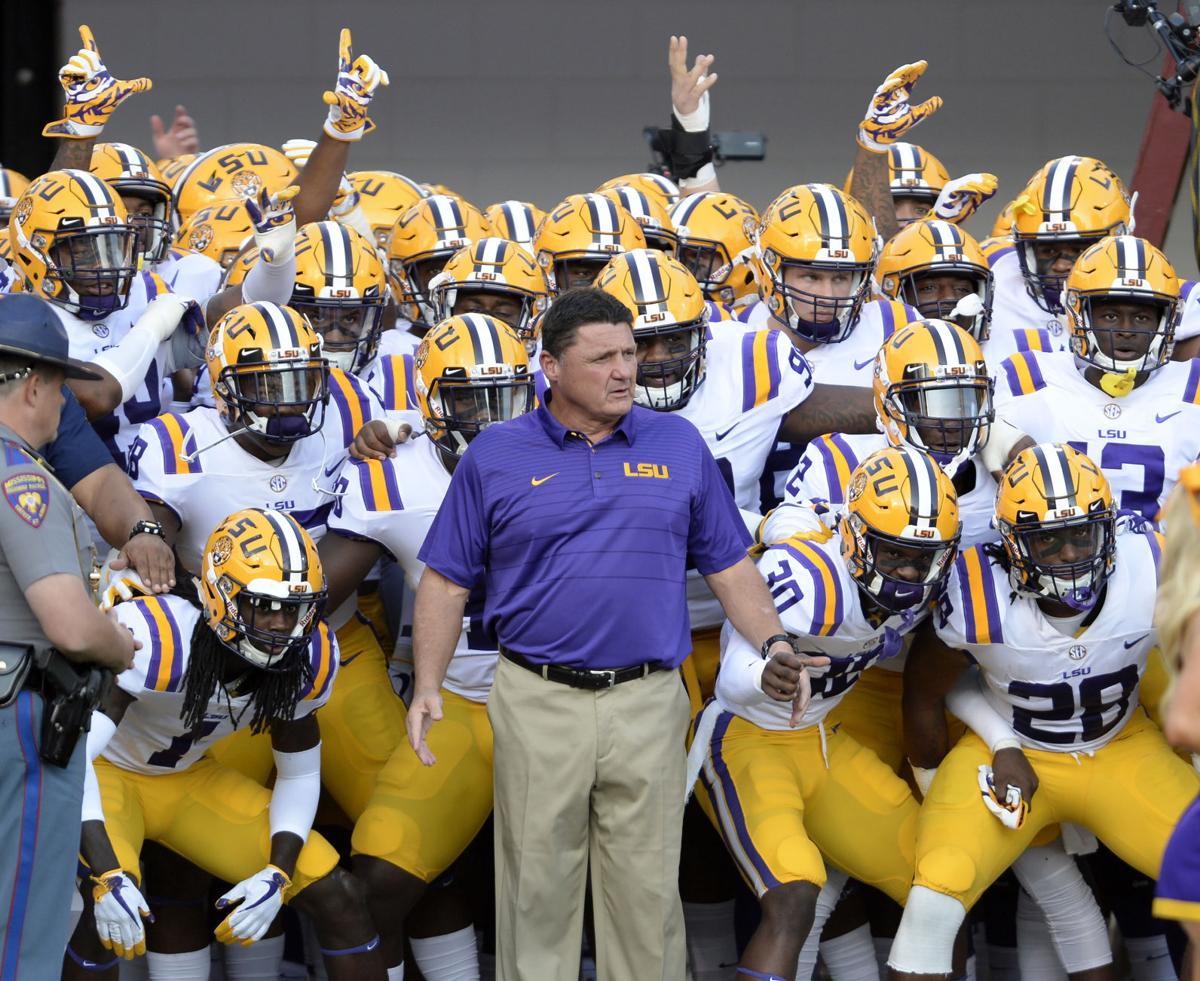 The coach in front of the LSU football team