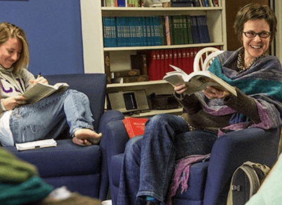 Religion students at Cal Lutheran reading books and laughing