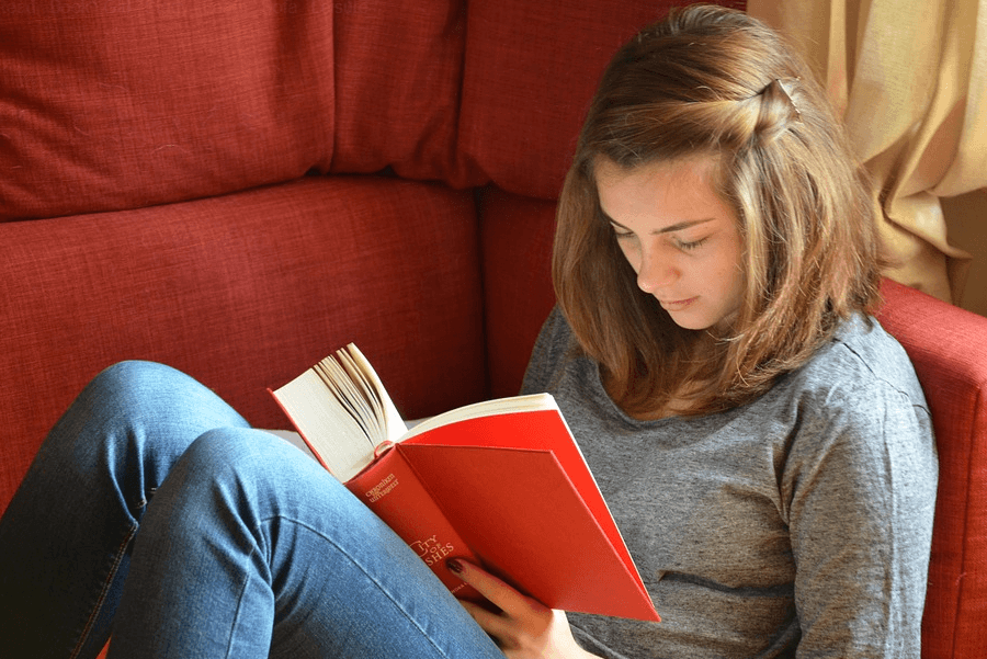 female student reading bible