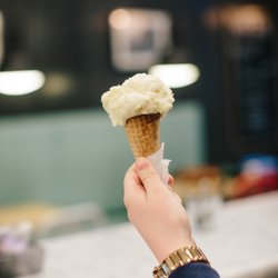 a person holding up icecream