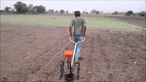 the man showing how to use agricultural equipment