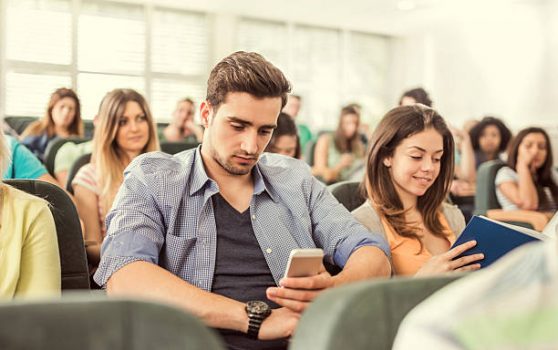 male student using phone during class
