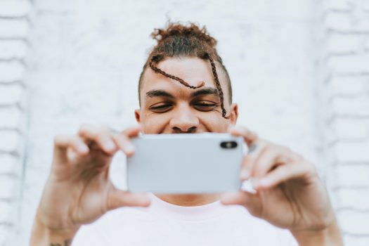 young man using phone to watch videos