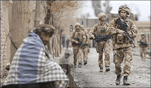 Armed soldiers patrolling a street 