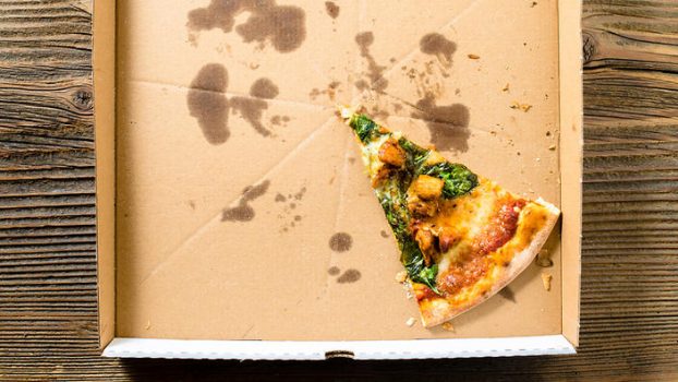 one last pizza slice in pizza box but with minimal grease on the box so it is recyclable.