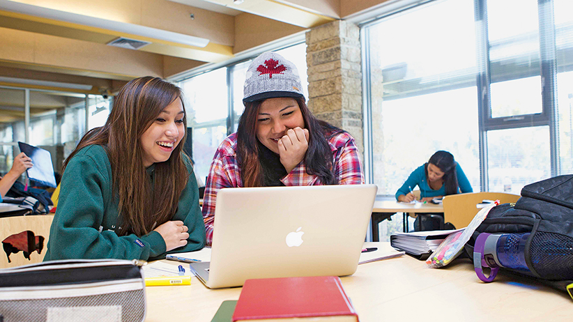Students studying with their laptop at the University of Manitoba.