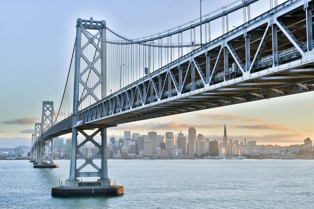 A long bridge constructed over a very wide river.