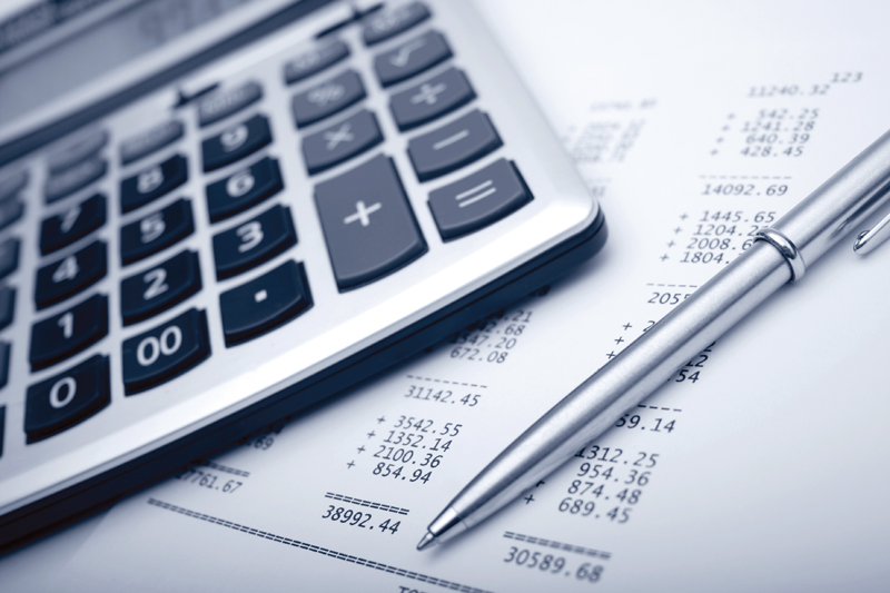 A calculator, a pen and some financial records