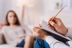 PIcture of person writing notes in a counselling session