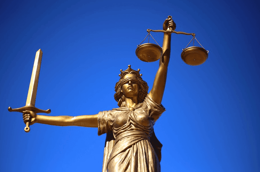 a female  justice statue holding a sword and a justice balance