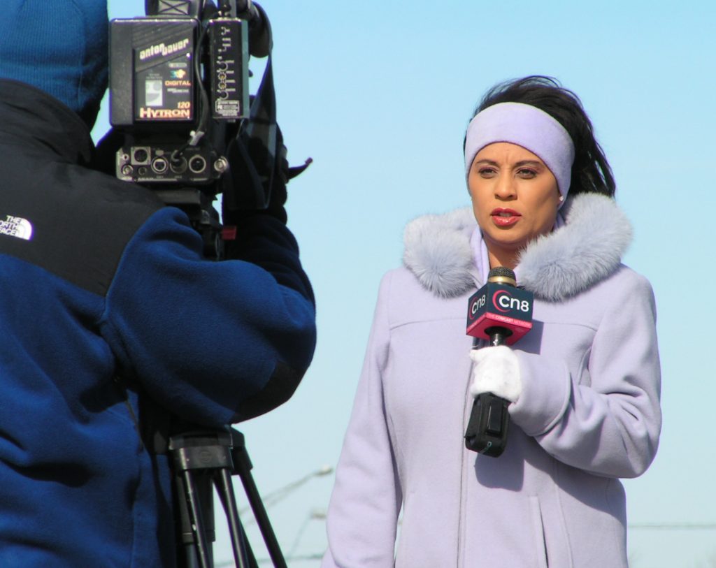 reporter in front of camera
