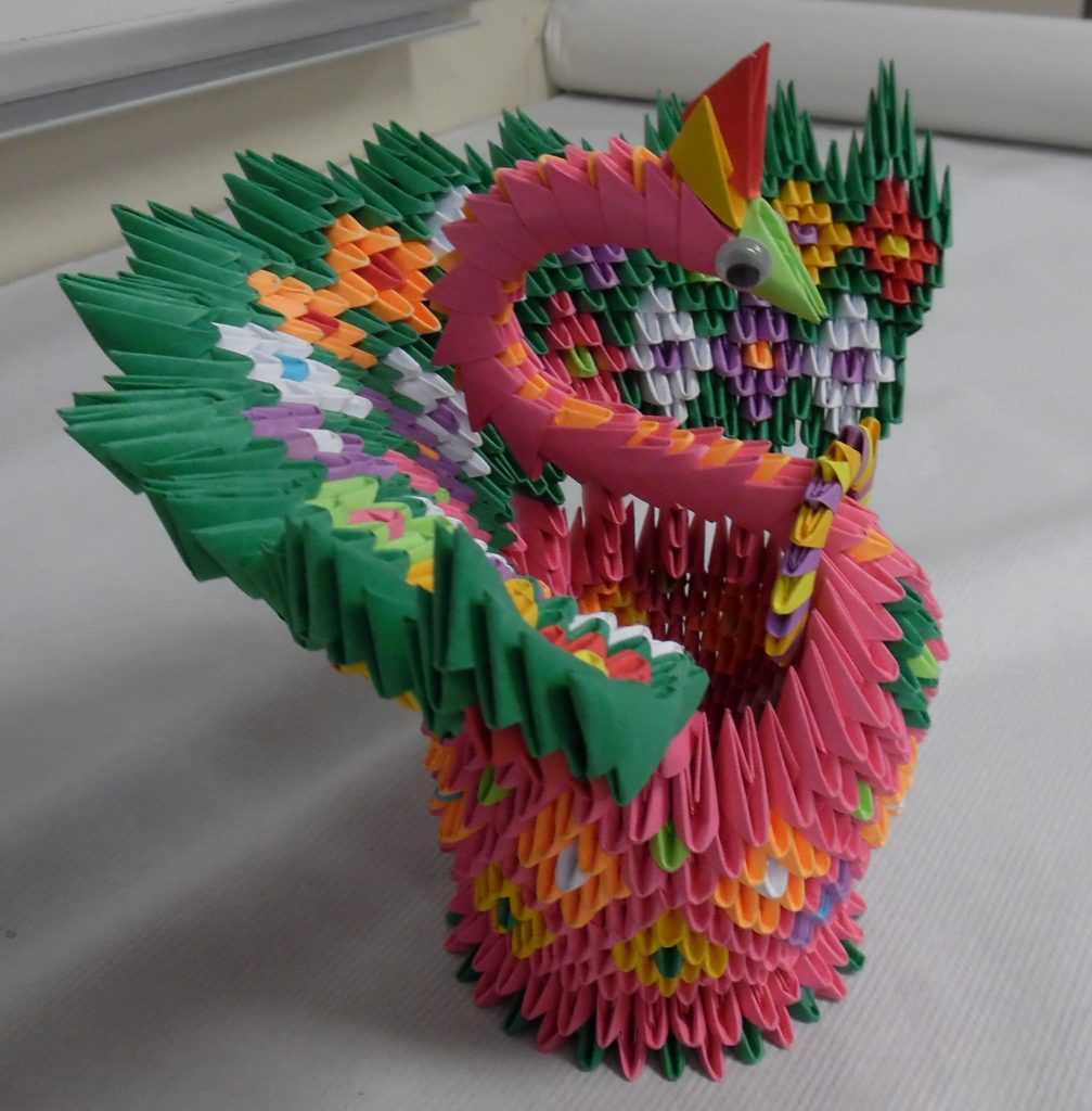 Student create origami dragons.