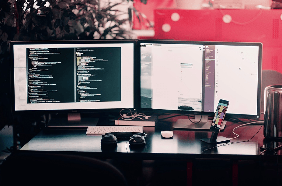 two computers with codes running