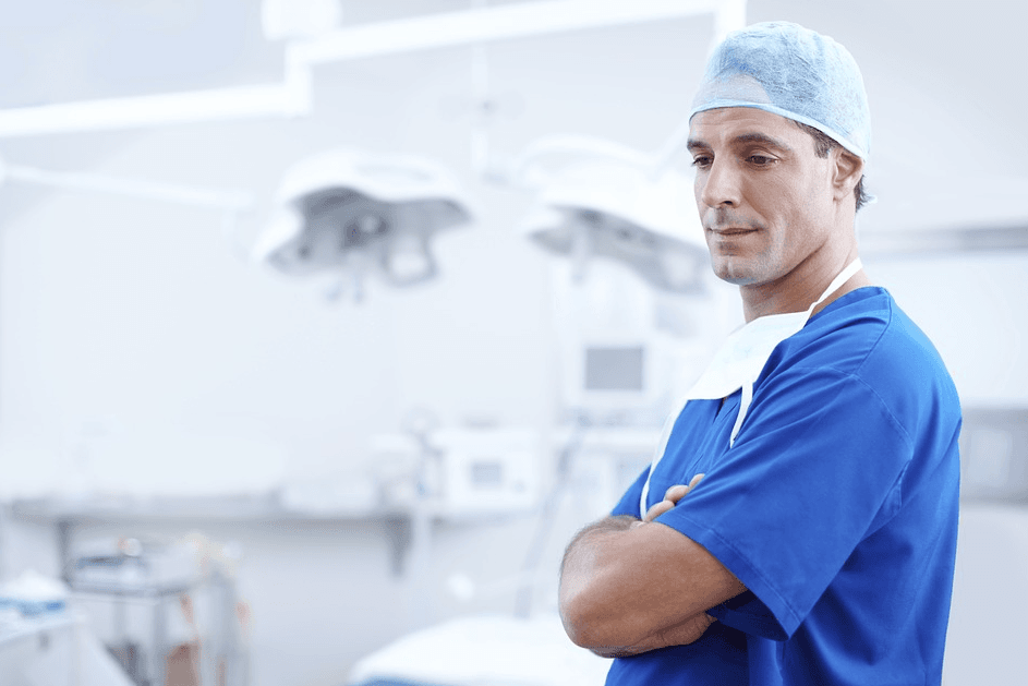 doctor wearing a surgical mask, coat and cap