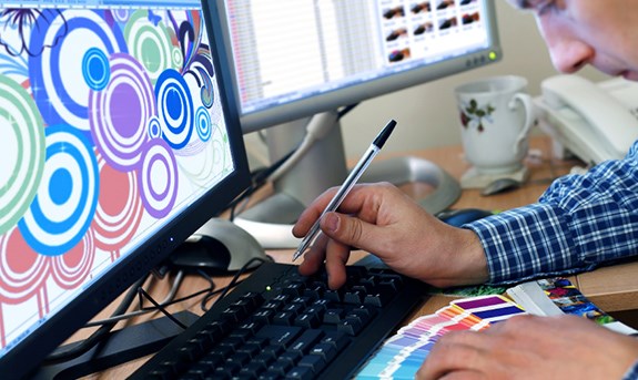 A graphic designer imaging on a computer