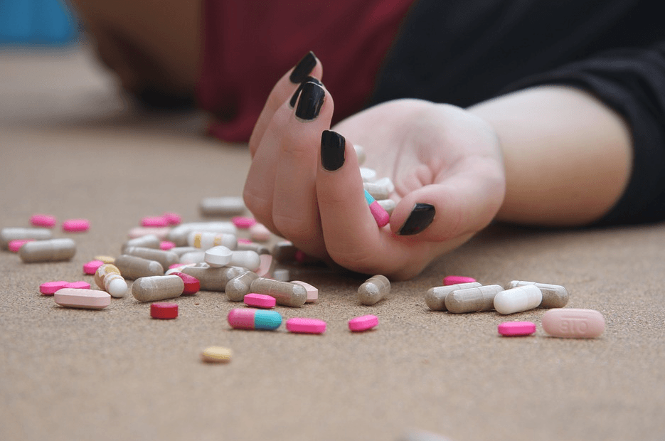 woman with pills on her hand