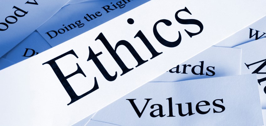 A poster written Ethics and other words on pieces of paper