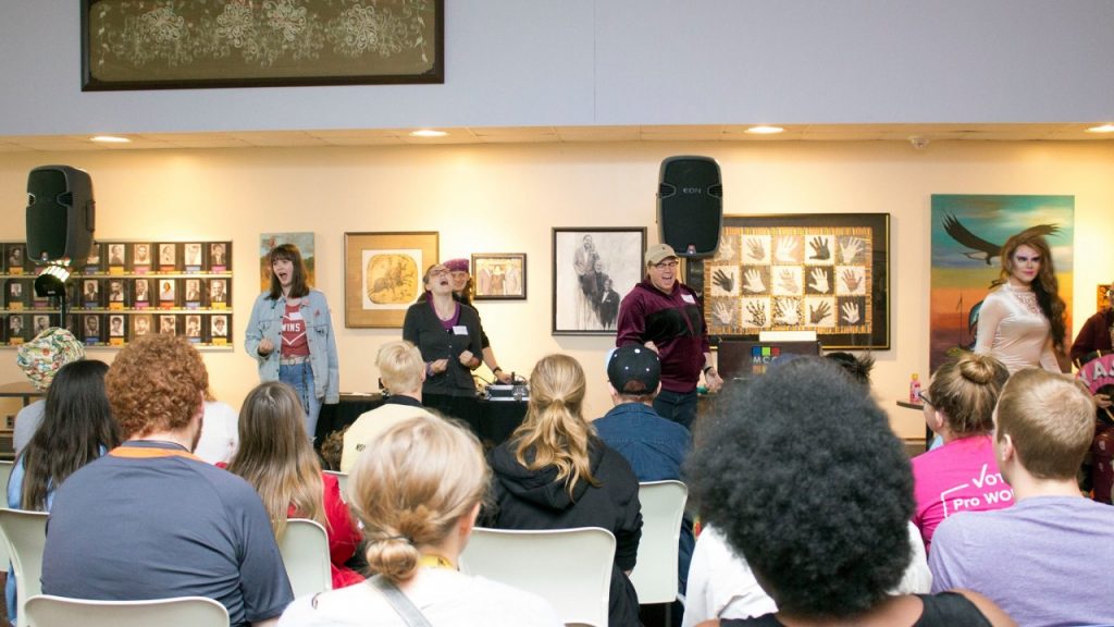 picture of people speaking in front of a crowd of people at an event