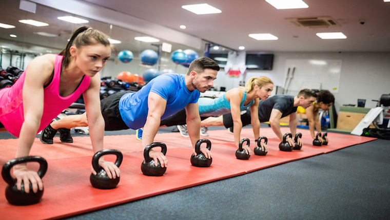 People conducting a fitness routine in a gym
