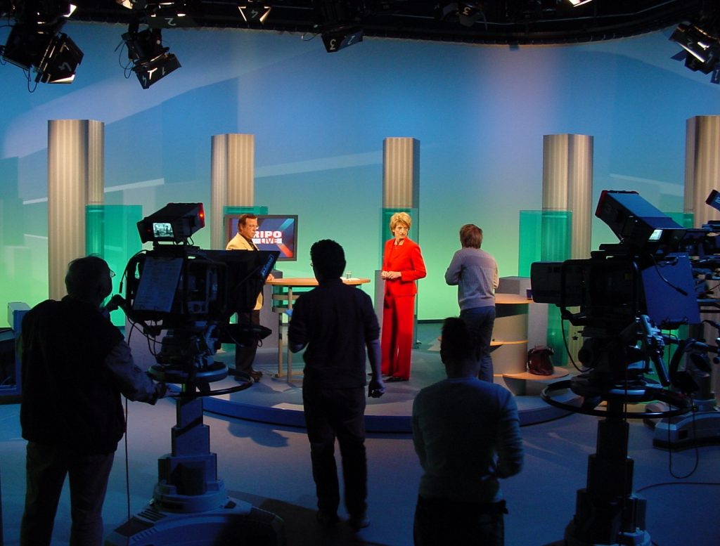 A broadcasting team inside a studio