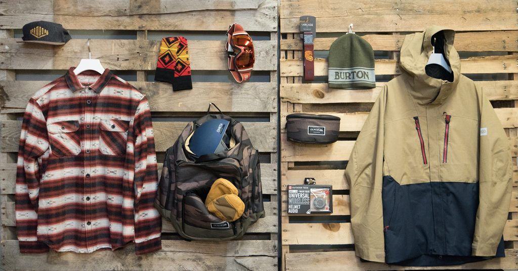 jackets shirts and other clothing and accessories laying down on a table