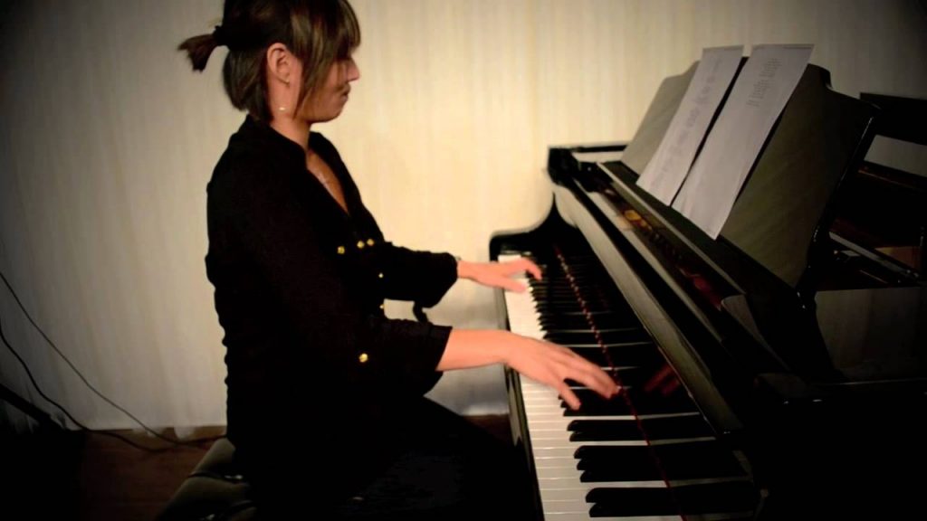 A female playing a piano