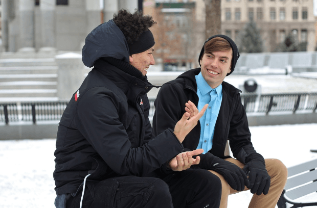 two guys having a conversation outdoor during winter