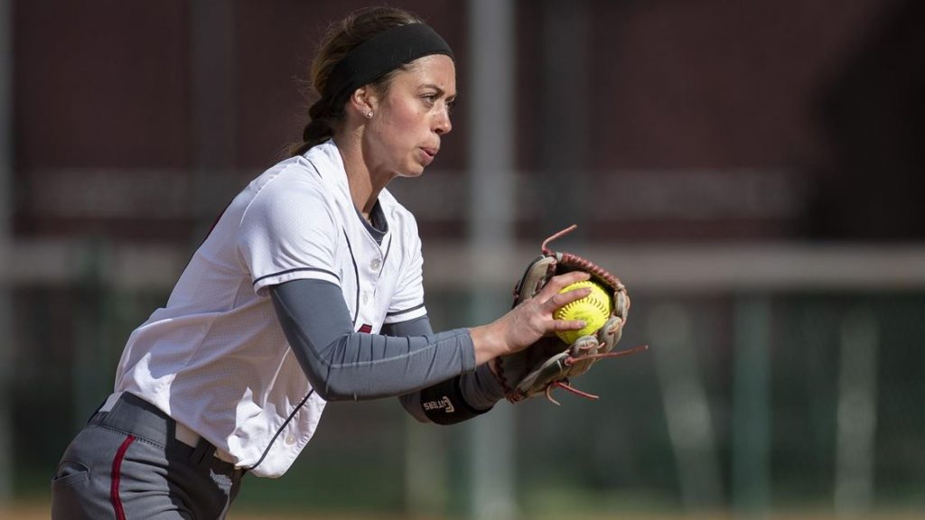 A female Softball player on the pitch