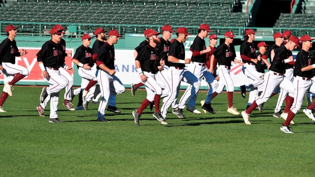 The UMass baseball team jogging on the pitch